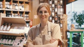 A woman, small business owner, proudly smiles in her wine store, showing confidence in her successful enterprise. She stands by shelves with bottles, exuding joy and accomplishment - Powered by Shutterstock - Get 15% off with code: PIKWIZARD15