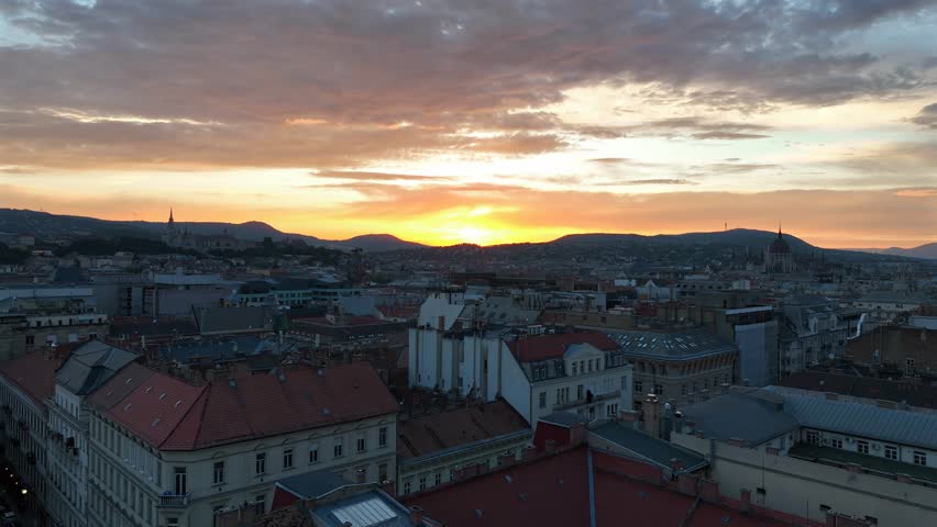 Amazing sunset over Budapest city. Downtown buildings roofs in this video. Colorful sundown on the background
