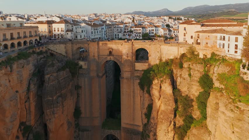 Ronda, Spain. Aerial view of the New Bridge over Guadalevin River in Ronda medieval town at sunset, Andalusia, Spain. Famous UNESCO heritage city and Puente Nuevo bridge at sunset