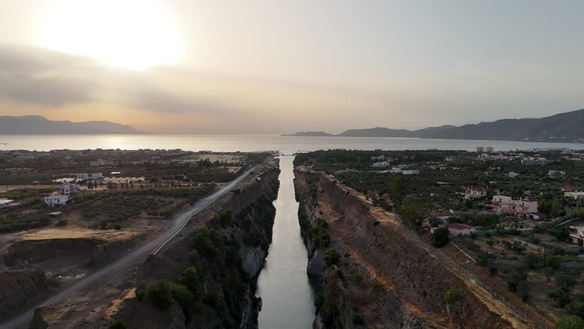 Corinth Canal, Greece. The Corinth Canal is a sluiceless shipping canal in Greece, connecting the Saronic Gulf of the Aegean and the Gulf of Corinth of the Ionian Sea, Aerial View