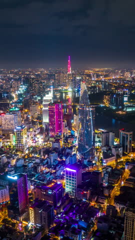 Vertical video, Hyperlapse Aerial view of beautiful night traffic and city lights in Ho Chi Minh City, Vietnam.	
