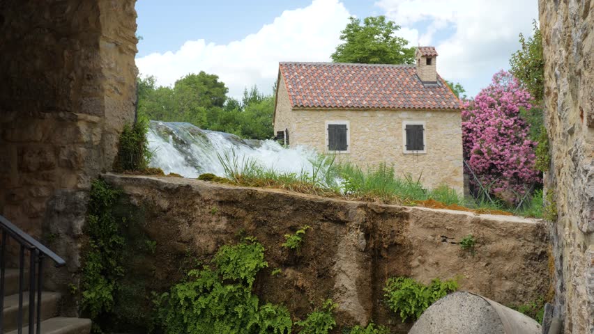 Idyllic water mill in Krka National Park, Croatia. Water flowing down waterfall