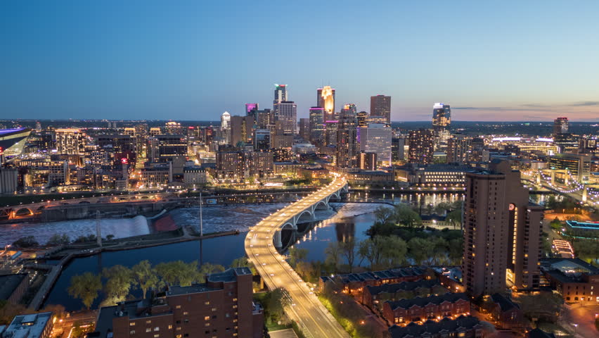 Minneapolis, Minnesota, USA downtown city skyline over the river at dusk.