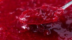 Bright red cranberry sauce spreading and taking with a spoon close up - Powered by Shutterstock - Get 15% off with code: PIKWIZARD15