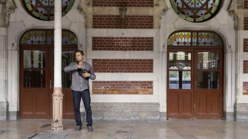 A man uses a telephone while standing at an old train station in Istanbul, Turkey, October 2023