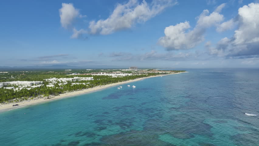 Panning from the right to the left side of the frame, showing the full stretch of the island beachfront in the Dominican Republic located in the Caribbean. 