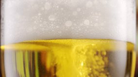Beer in a beer glass, forming effervescent bubbles and a frothy head. Beer foam flows down the glass. . Detail shot, macro. beer capturing the spirit of octoberfest celebration . alcoholic drink - Powered by Shutterstock - Get 15% off with code: PIKWIZARD15