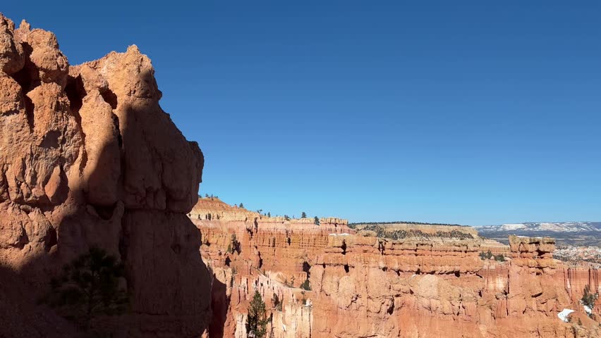 A pan from left to right across the rock formations and hoodoos of Bryce Canyon National Park, Utah. Includes a view of the Thor