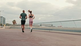 Multi-ethnic couple training together in summer on the seafront. Street work out concept, couple goals and motivation. Happy fit people are cheerfully doing sports - Powered by Shutterstock - Get 15% off with code: PIKWIZARD15