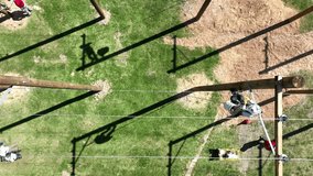 Top down drone video of lineman working on poles during APPA lineman rodeo 2024. Drone video of linemen working. Team of linemen competing, blue collar workers, blue collar families, linemen
