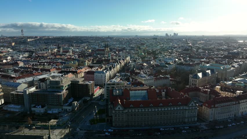 Prague, Czechia, December 2022. Drone pulls above the Svatopluk Čech Bridge on the Vltava river looking south towards the Old Town with Church of Our Lady Before Týn in the distance.