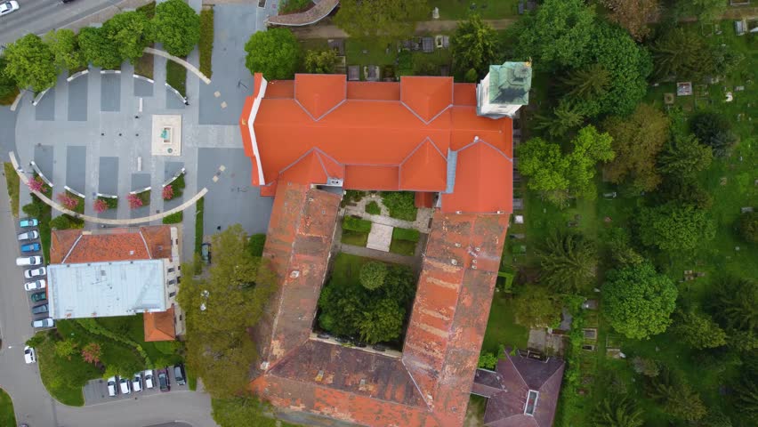 View from above red roof of house tower and garden with green trees, Szombathely, Hungary
