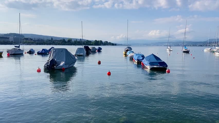 Boats parked and floated on Zurich lake in Switzerland 