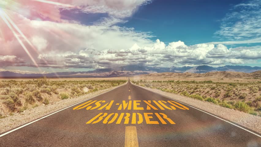 A road and sign on the border between USA and Mexico