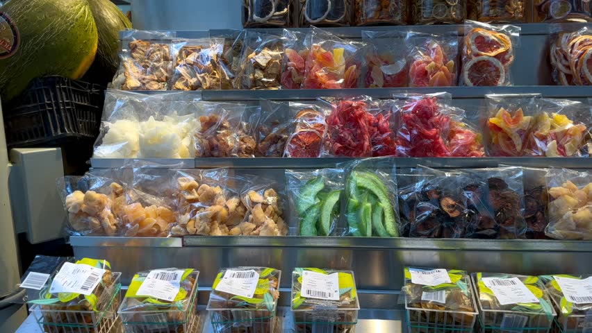 Counter with colorful dry fruits packs. Variety of healthy snacks.