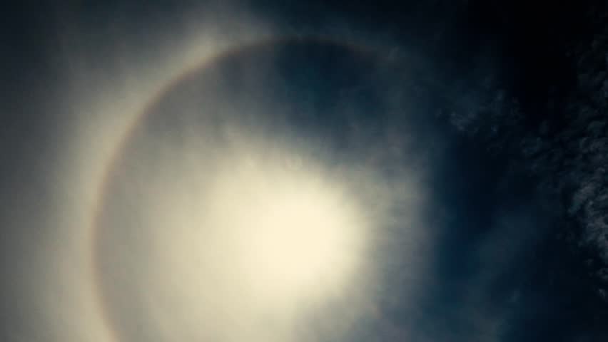 stunning sun halo captured in the middle of the day, set against a clear blue sky. This natural phenomenon creates a captivating ring around the sun, offering a perfect backdrop for creative