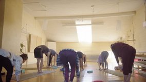 Yogis in class led by instructor go into Warrior 1 pose and then stretches over - Powered by Shutterstock - Get 15% off with code: PIKWIZARD15