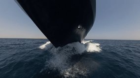 Closeup view showing bow of a large luxury private motor yacht under way sailing on tropical sea with bow wave - Powered by Shutterstock - Get 15% off with code: PIKWIZARD15