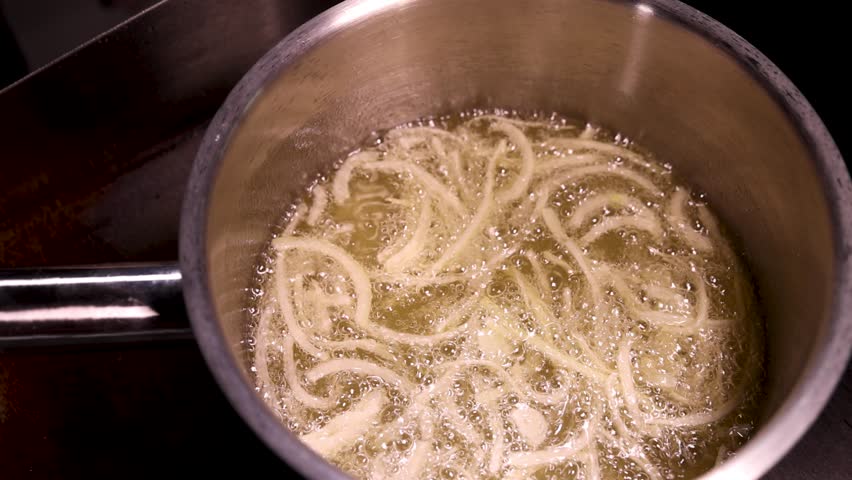 Fry onions in oil until golden and crispy in a saucepan to enhance the dishs aroma and flavor