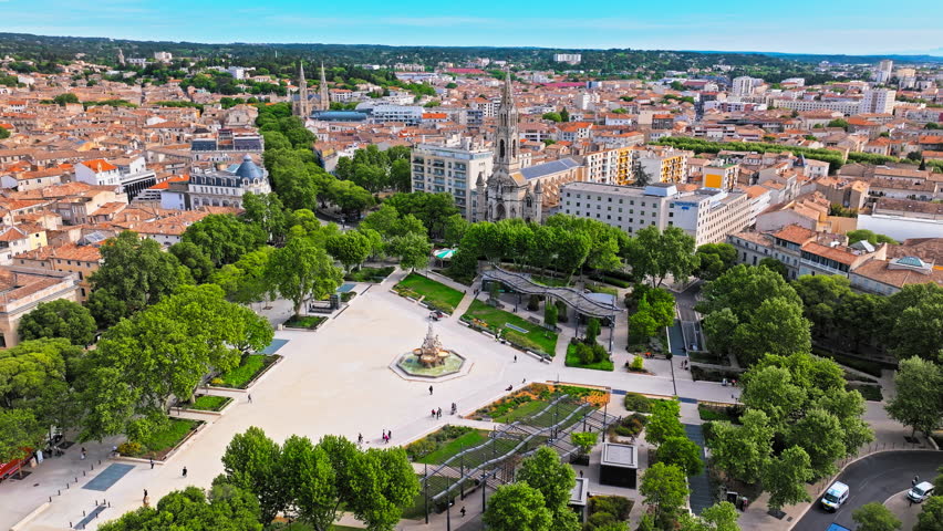 Aerial view of a high stone watchtower, part of the Roman city wall with panoramic views in Nimes. Cultural landmark Tour Magne in Nimes, France.