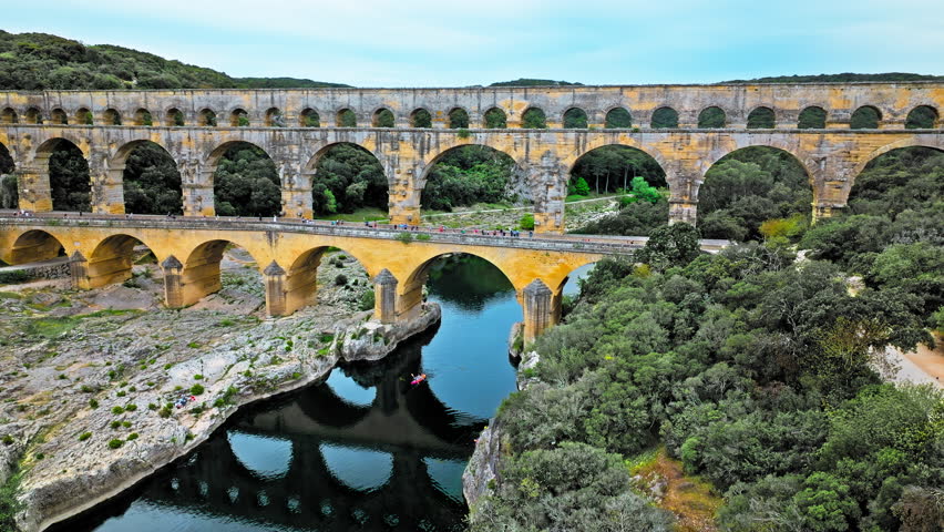 Aerial view of the aqueduct bridge with arched tiers in France. Drone view of Pont du Gard the highest Roman aqueduct bridge in the world.
