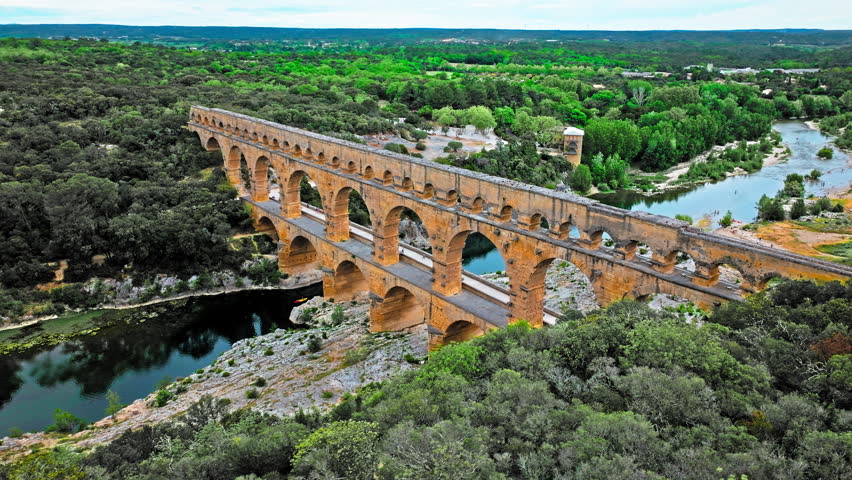 Aerial view of the aqueduct bridge with arched tiers in France. Drone view of Pont du Gard the highest Roman aqueduct bridge in the world.