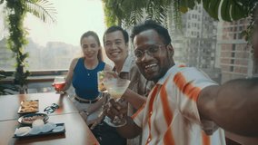 POV of three diverse friends taking selfie while having drinks, meeting at trendy cafe - Powered by Shutterstock - Get 15% off with code: PIKWIZARD15