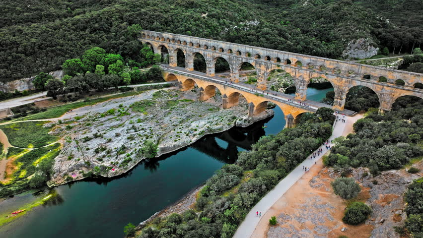 Aerial view of the aqueduct bridge with arched tiers in France. Drone view of Pont du Gard the highest Roman aqueduct bridge in the world.