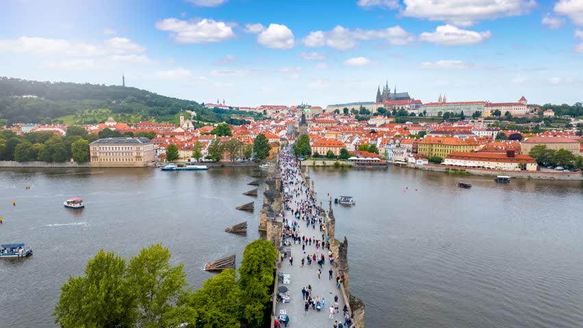 Motion time lapse view of the Charles Bridge and old Lesser town of Prague during a sunny summer day, Czech Republic