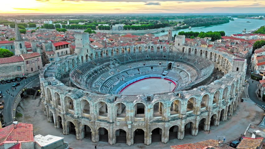 Aerial view of Ancient, 2-tiered Roman gladiatorial amphitheatre hosting bullfighting and community events. Panorama of ancient town Arles in Provence and Cote d