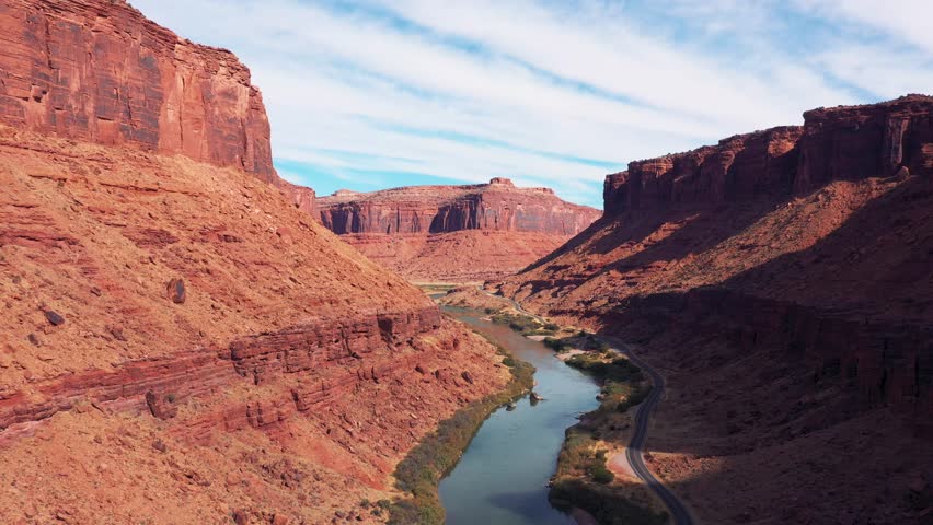 Travel by car through national parks of USA with picturesque landscapes of nature. Flying over Colorado River in rocky gorge of red canyon similar to Grand Canyon. Moving forward to an unknown goal