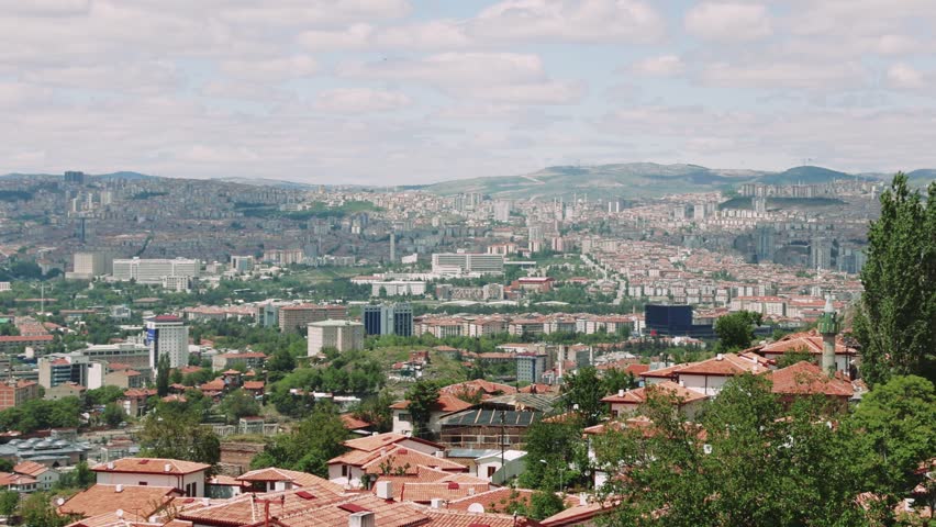 A stunning view of Ankara, Turkey, blending history and modernity. The cityscape from a high point shows diverse architecture and vibrant life