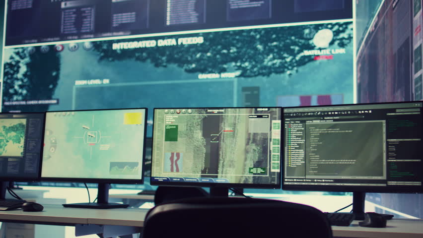 Government anti terrorism operation room equipped with a big display and surveillance on satellite radar cctv used for reconnaissance. Empty military command center with high tech.