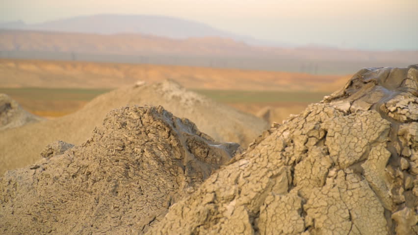 Mud volcano. Always active mud volcanoes surrounded by mountains