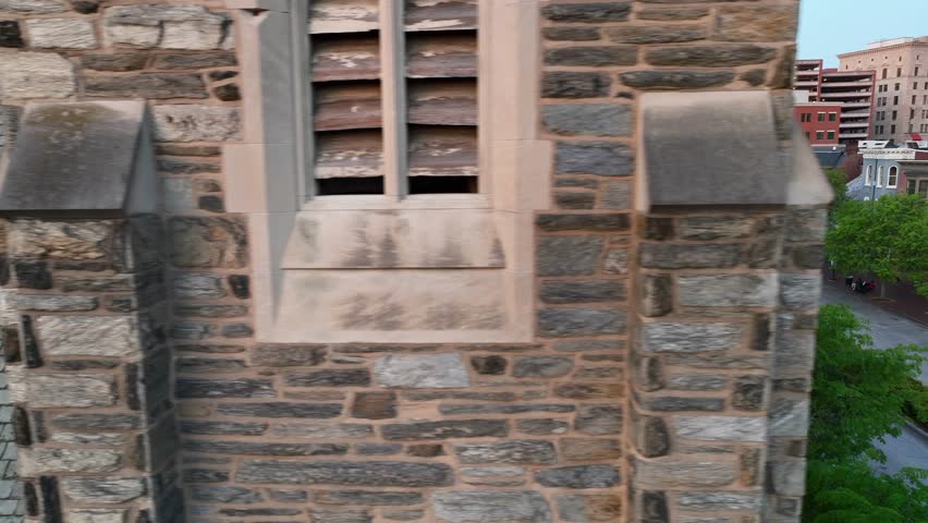 Aerial revealing shot of parking street with Pennsylvania State Capitol of Harrisburg Town in Background. Sunset time in downtown of american town at sunset.