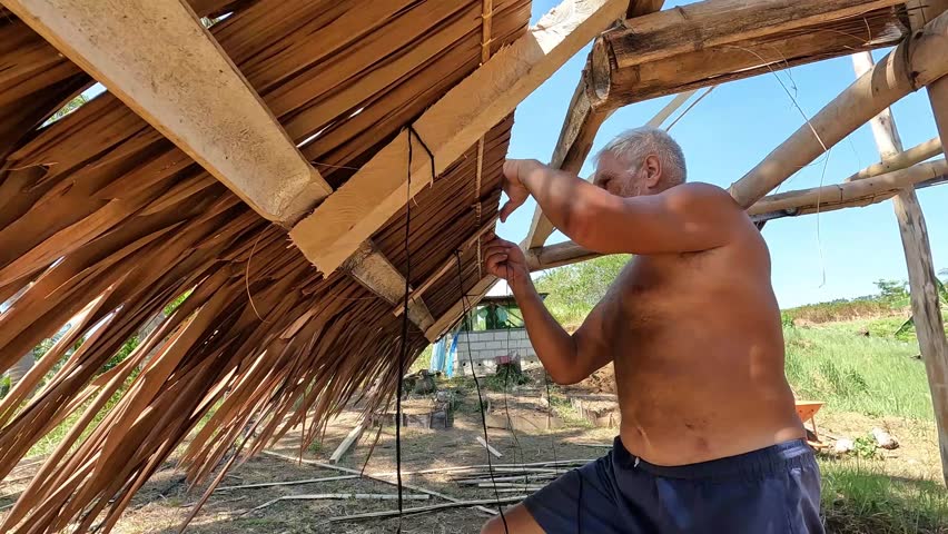 old man installing native roof 