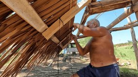 old man installing native roof  - Powered by Shutterstock - Get 15% off with code: PIKWIZARD15