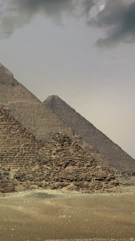 Timelapse with sunset clouds over great pyramids at Giza Cairo in Egypt . Vertical video