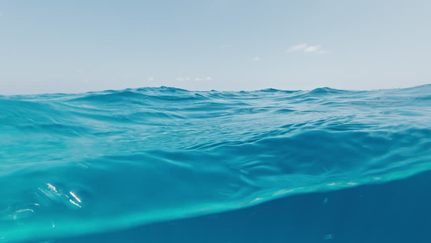Underwater splitted view of the calm tropical sea in the Maldives