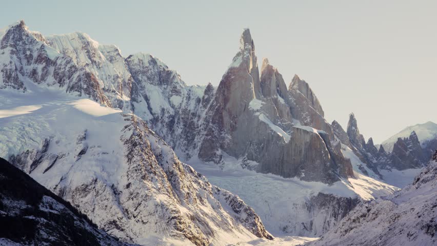 Snow-covered Cerro Torre peak in Patagonia, Argentina. Straight-on camera angle, pan left to right