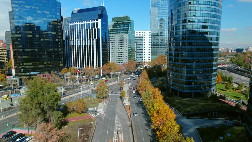 Aerial fly Providencia commercial neighborhood of Santiago de Chile, high rise buildings and traffic in autumn daylight