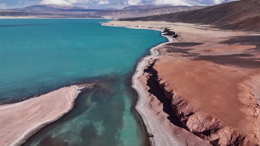 Blue lagoon near Ojos del Salado volcano in Chile South America majestic nature volcanic landscape. Aerial view of blue lagoon by Ojos del Salado volcano in Chile grandeur of South American nature