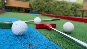 Mini golf close-up, colorful golf putters, balls - Powered by Shutterstock - Get 15% off with code: PIKWIZARD15