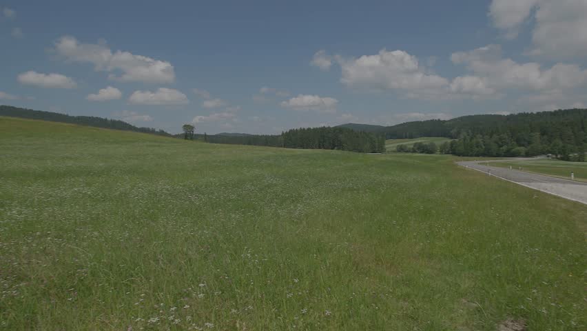 single moped driving to scenic landscape in Muehlviertel, Upper Austria