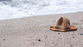 Straw hat on a sand beach of sea. Vertical video. - Powered by Shutterstock - Get 15% off with code: PIKWIZARD15