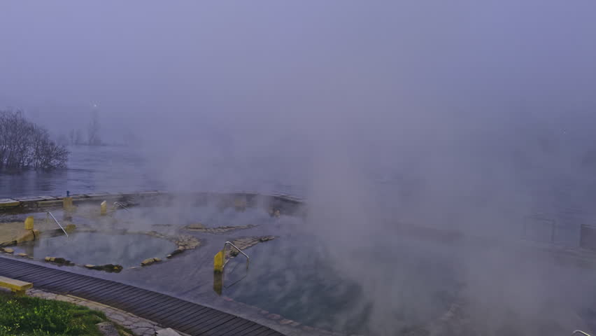 Steaming hot springs on a foggy morning