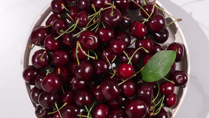 dark red cherry top on plate fruit rotation food