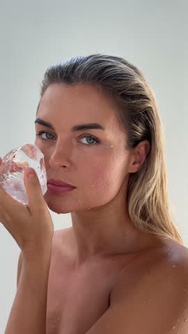 Beautiful woman doing facial beauty spa treatment with ice