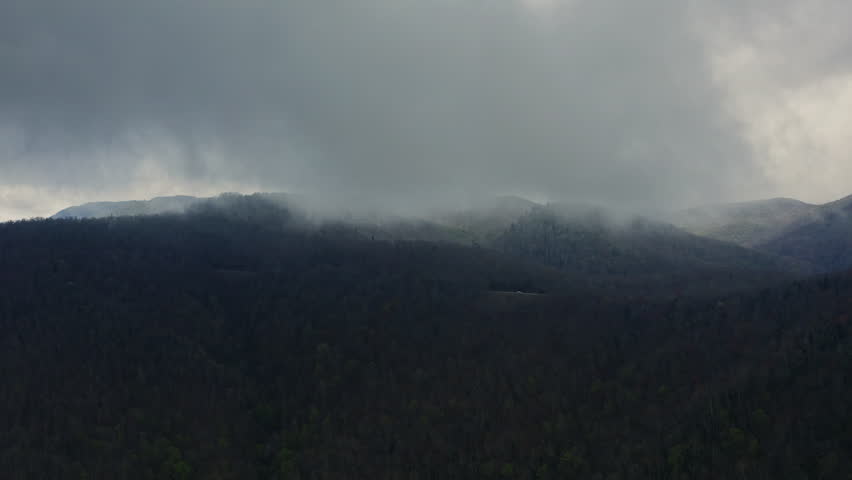 Aerial of moody fog sitting over Blue Ridge Parkway in Brevard North Carolina