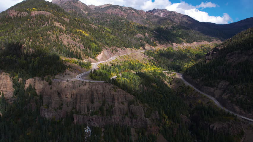 Aerial View of Wolf Creek Mountain Pass Under Clouds Shadows, Curvy Road and Overlook, Colorado USA